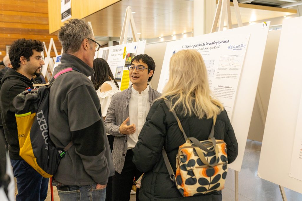 A student presents an academic poster at a research symposium