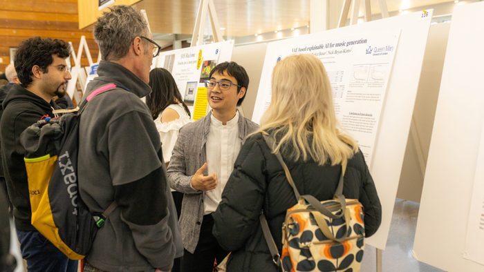 A student presents an academic poster at a research symposium