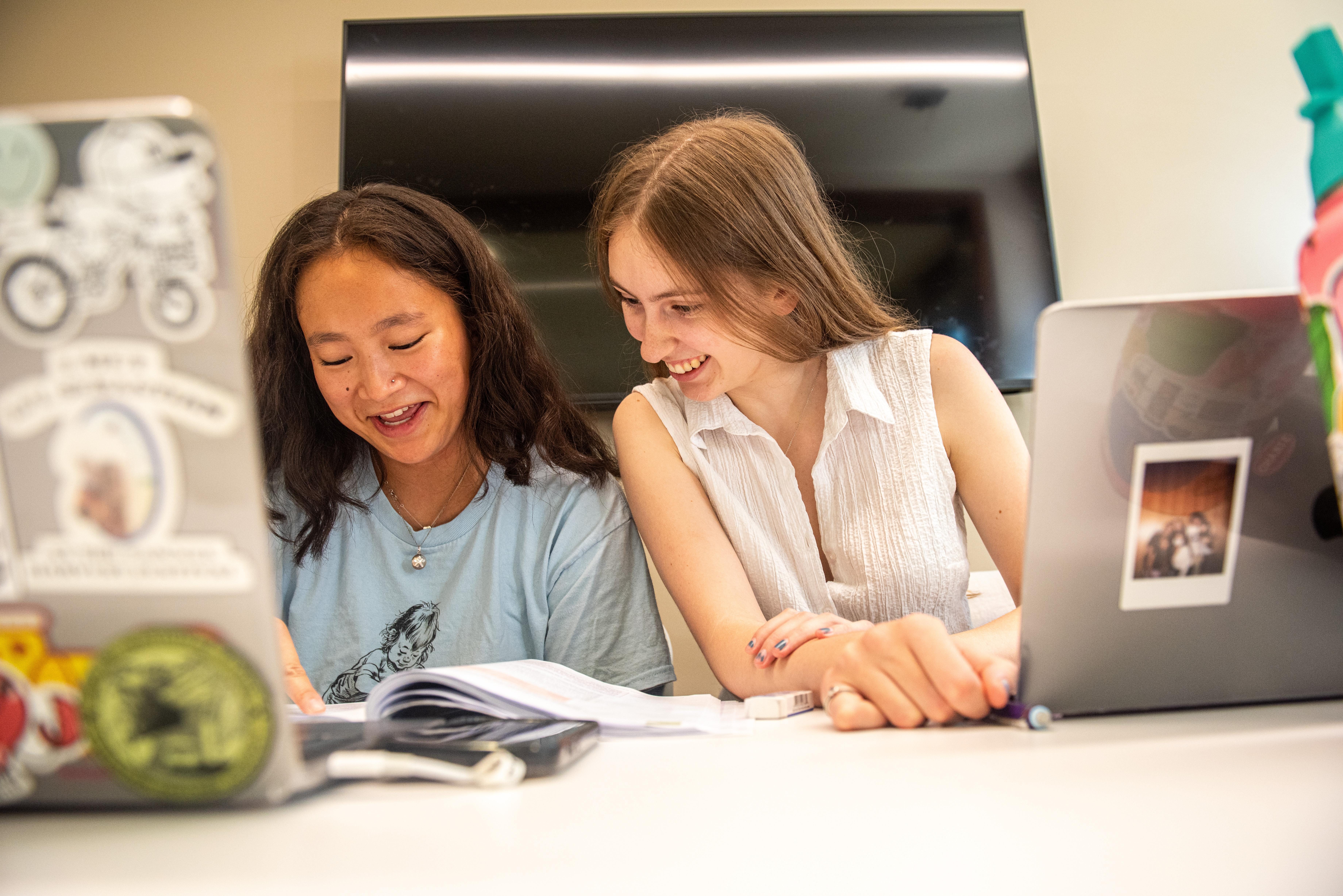 students reading notes and studying together