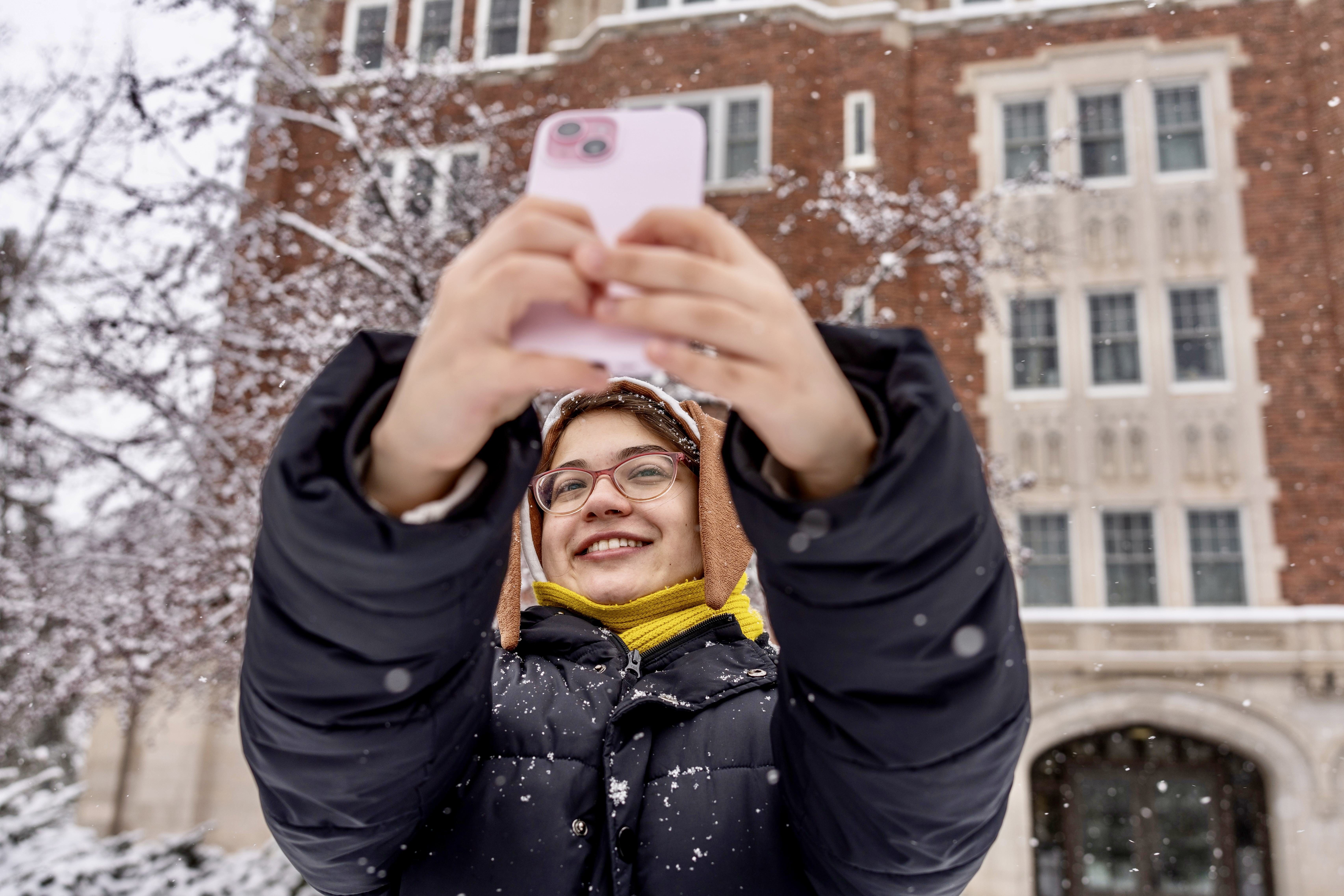 student takes a selfie in the snow