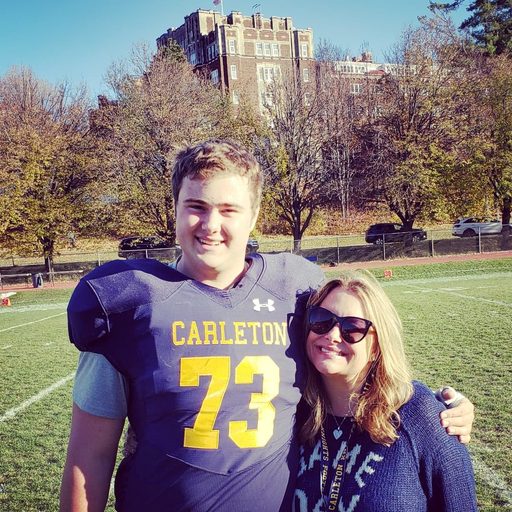 Parent and Carleton student on football field