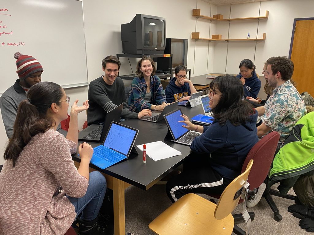 Lab members seated around a table