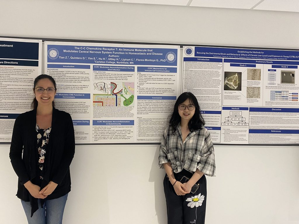 Professor and student in front of an academic poster at a conference