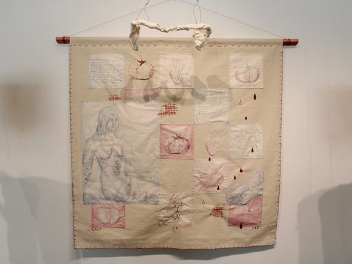 a hanging tapestry of etchings depicting the human form, poetry, and fruits is joined by two paper mache sculptures of internal organs