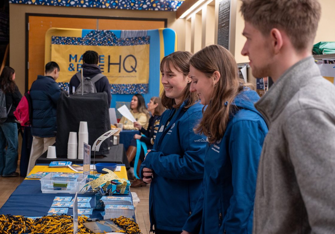 Students help out at the Maize and Blue Daize info desk