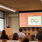 Librarian, Kate Savageau-Eidem gives a lecture to a group of staff members on the topic of Neurodivergence in the the workplace .