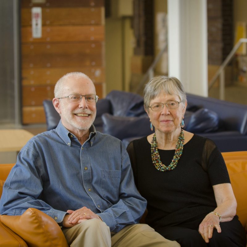 Doug and Ruth Crane seated on a couch