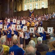People holding signs with a fundraising total