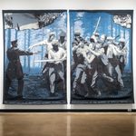 A pair of tapestries hang side by side. They depict a black-and-white photo of an officer pointing a gun at a group of men wielding baseball bats. There is a blue treescape background. The upper corners of the scene look as if they are torn off, revealing an image of a crowd gathered in a city street and a group of women running a canteen for striking laborers.