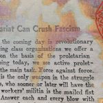 Cropped detail view of a textile with newspaper text and a partial headline reading “Can Crush Facism”, against a white, orange, and purple background which are layered in an almost typographical way. Legs outlined in red, stitched thread are mid step on the right side of the image.