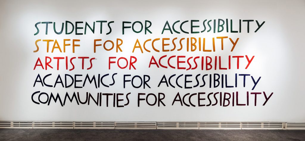 A mural with colorful lines of text reading: Students for accessibility, staff for accessibility, artists for accessibility, academics for accessibility, communities for accessibility