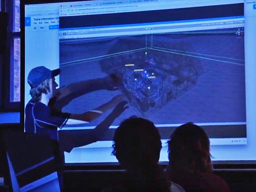 A student interacts with a projected 3d model on a screen