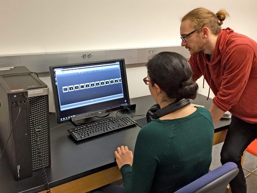 Two students look at a computer monitor in the perception lab.