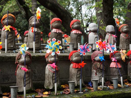 Decorated Jizo statues at a shrine in Tokyo