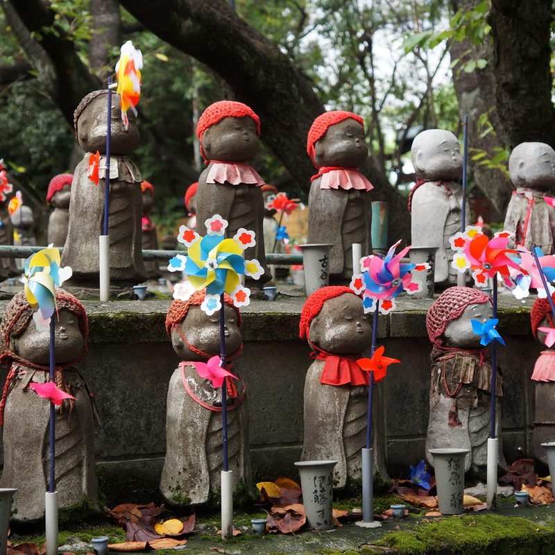 Decorated Jizo statues at a shrine in Tokyo