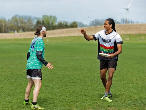 Two students playing Ultimate Frisbee