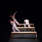 Dancers using benches as props
