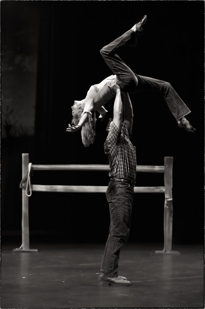 A male dancer lifting a female dancer above his head