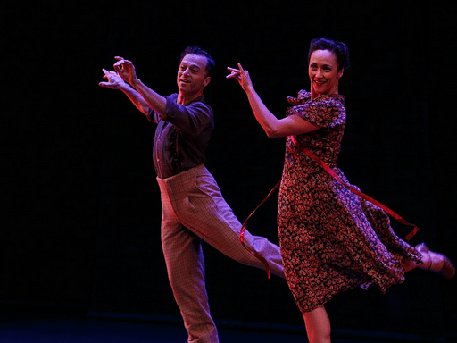 Two dancers jumping in synchrony