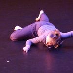 A dancer laying on stage