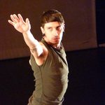 A dancer with his arm stretched out