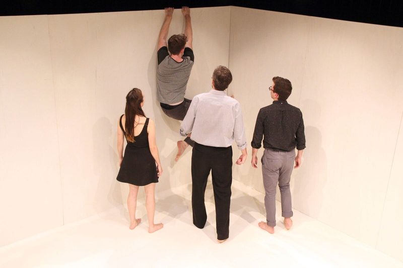Man climbing a wall to escape from the other actors