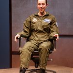 A pilot sitting in a chair, smiling