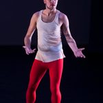 A dancer in red pants