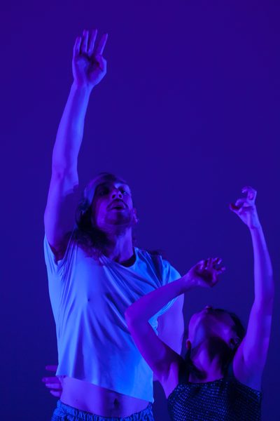Dancers standing with their arms up