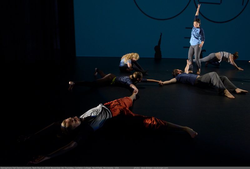 Dancers lying on the floor and one dancer standing