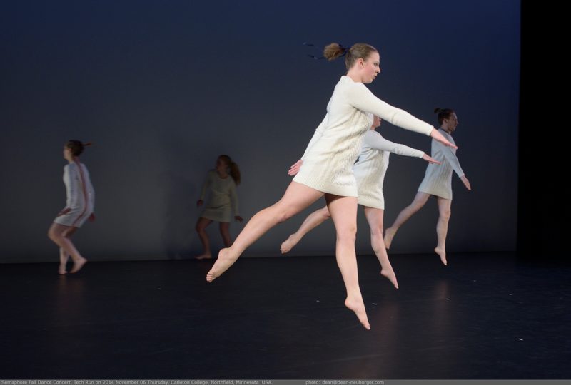 Dancers wearing white dresses in mid-air