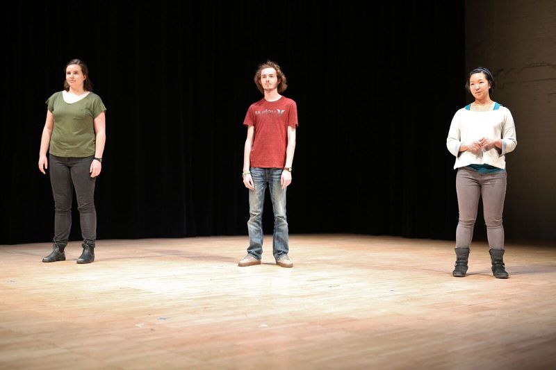 Three actors standing on stage