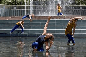 Dancers performing in a fountain