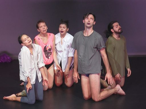 Five dancers on their knees looking sad.
