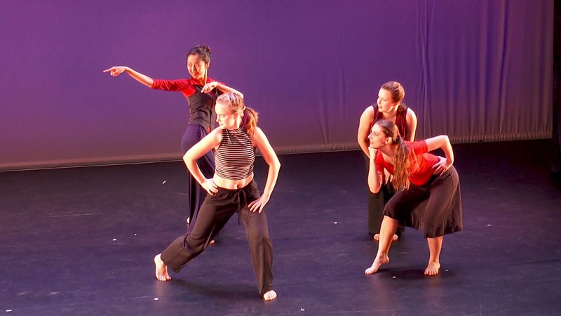 Four dancers looking off to the left, each with a different pose.