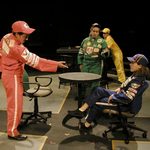 Actors wearing race car driving outfits