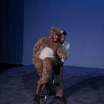 A man and a bear on a bike