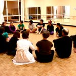 Dancers sitting in a circle during a dance workshop with Eiko Otake
