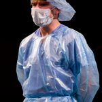 A man wearing scrubs and a surgery mask