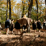 Semaphore dancers standing together in the woods