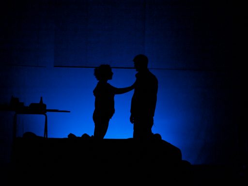 Silhouettes of a woman putting her hand on a man's chest