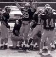 The football team celebrates on the field