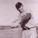 Schlaffer poses holding his baseball bat out like he is about to hit a pitch