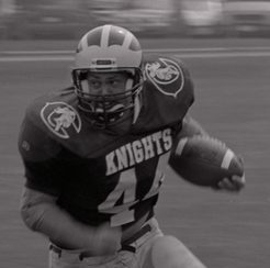 French (#44) scans the field for defense while running with the football