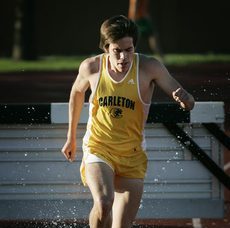 Bucy splashes through the water after hurdling over a steeplechase