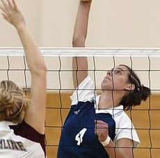 Beth jumps over the net to block the volleyball