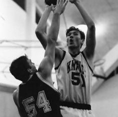 Wilhelm jumps over defending player to make a shot in basketball