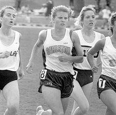 Kate runs on the outdoor track, flanked by competitors