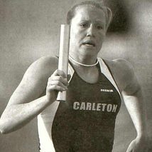 Colbenson running holding relay baton up near her shoulder