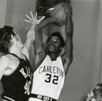 Smith, wearing #32, jumps to make a shot in basketball